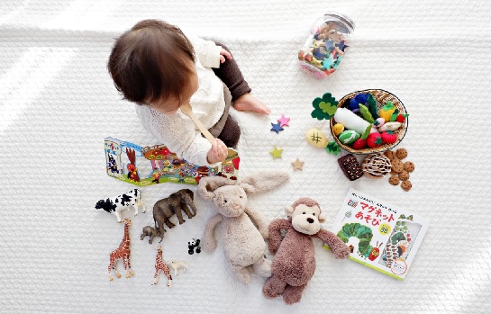 toddler surrounded by toys