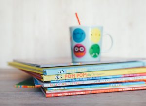 Stack of children books with mug on top